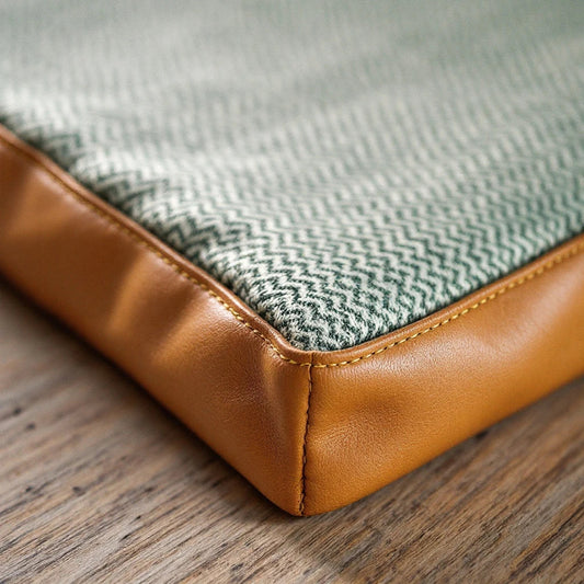 Larkwell The Cool Field Mat in sage green herringbone linen with chestnut tan leather trim and hand-stitched corners.