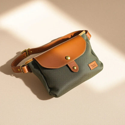 Larkwell The Field Pouch in olive waxed canvas with a tan leather flap, magnetic closure, and adjustable belt.